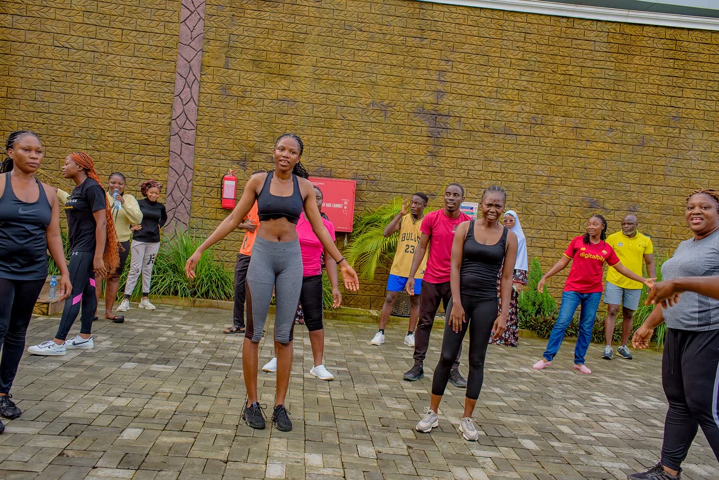 People following an outdoor aerobics session